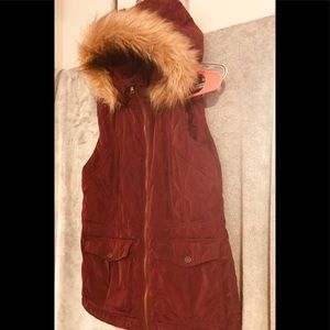 Sleeveless, dark wine colored jacket .